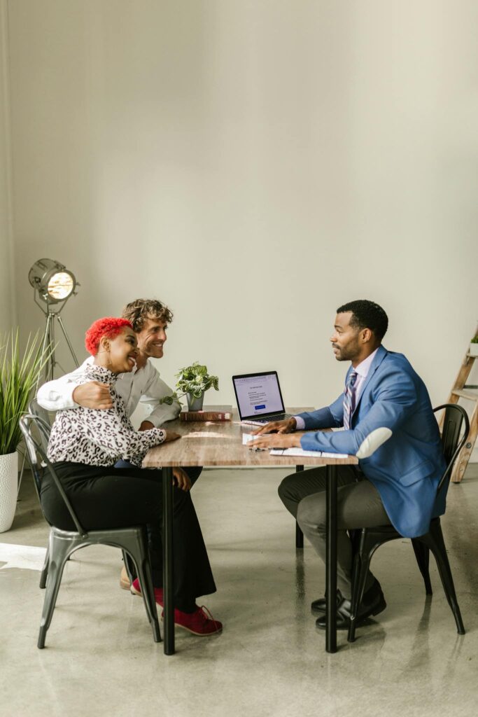 Photo by RDNE Stock project A professional financial advisor discusses options with a couple in a modern office setting.